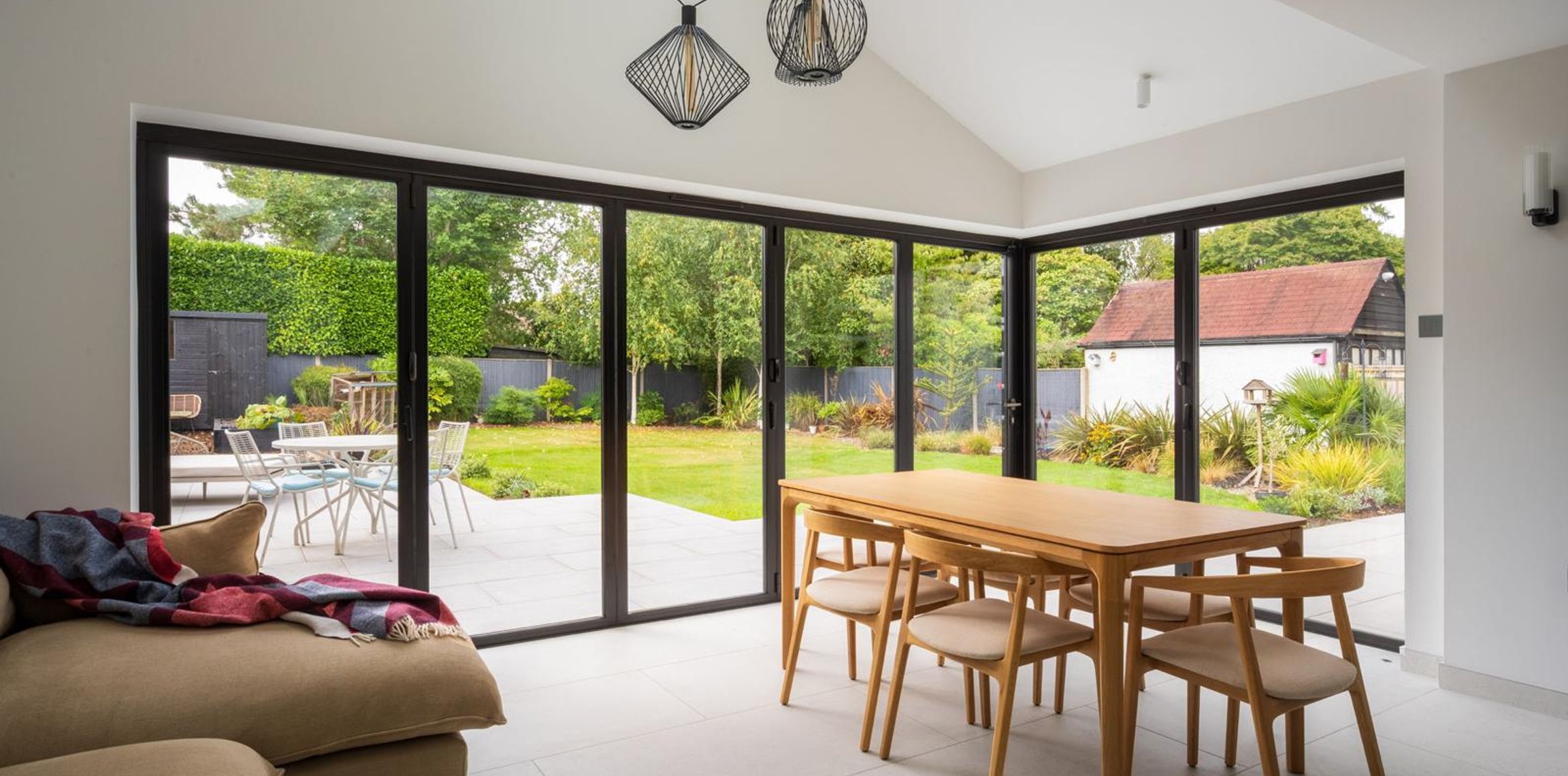 Open-plan living and dining room with bifold doors onto the garden