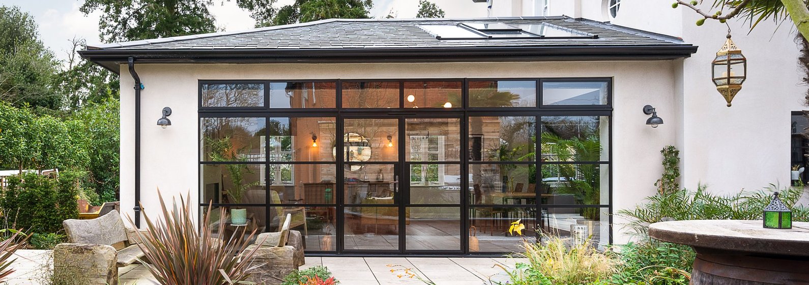 Crittall-style glazed garden room extension with patio by Westview Homes